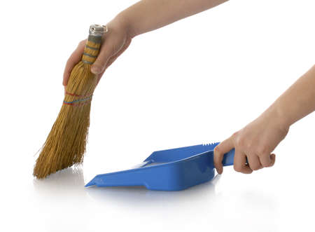hands holding broom and dust pan sweeping up with reflection on white backgroundの写真素材
