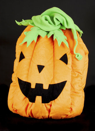 stuffed pumpkin on halloween on black backgroundの写真素材