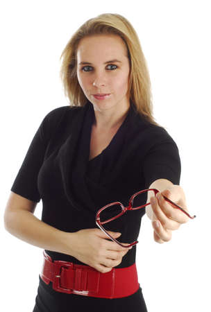 beautiful young woman in business clothing offering her glasses to viewer - focus on glassesの写真素材