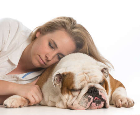 woman resting her head on her english bulldog on white backgroundの写真素材