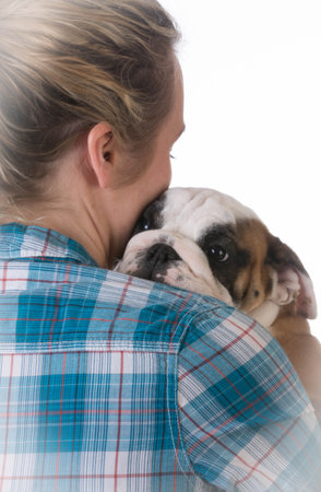 woman hugging new puppy on black background - 8 week old bulldogの写真素材