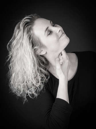 portrait of attractive woman on black backgroundの写真素材