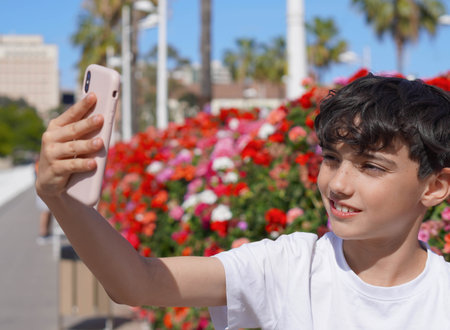 smiling preteen boy taking a selfieの写真素材