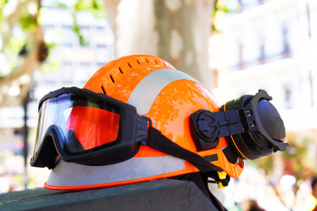 orange safety helmet equipped with goggles and headphones for sound protection. personal protective...