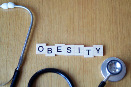 OBESITY. word written with wooden signs with stethoscope. health and medicine conceptの写真素材
