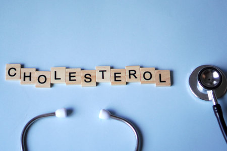 CHOLESTEROL, wooden letters and stethoscope with a soft blue backgroundの写真素材