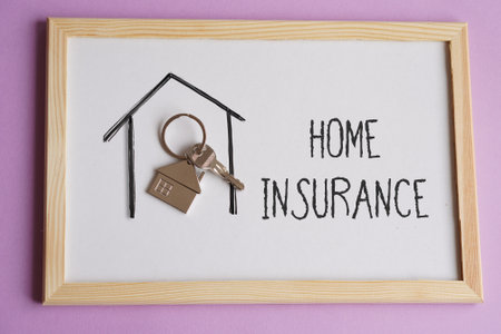 HOME INSURANCE. words written next to a house key.の写真素材