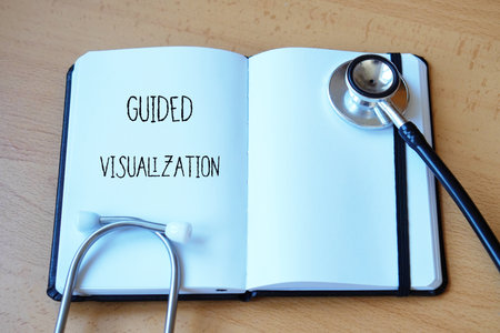 alternative medicine concept. guided visualization. words written in a medical notebook next to a...