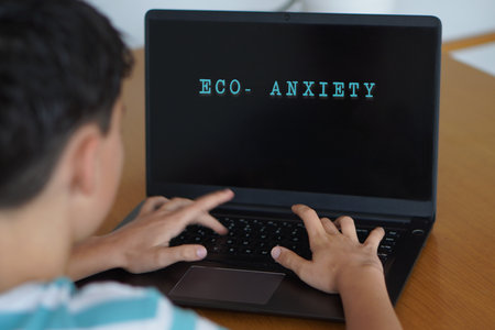 eco-anxiety and adolescence. Concept written on a teenager's laptop screen.