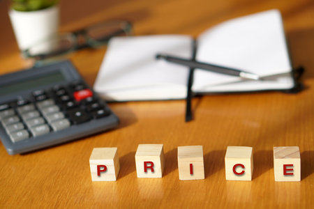 PRICE. Financial and business concepts. Letters on wooden blocks with calculator and notebook in the...