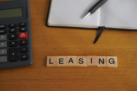 leasing. financial concepts. wooden letters with office supplies in the backgroundの写真素材