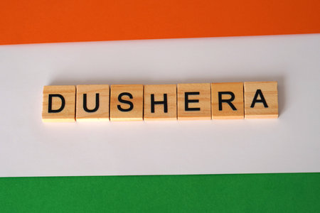 Dushera. Wooden letters with a textured paper background in the colors of the Indian flag.