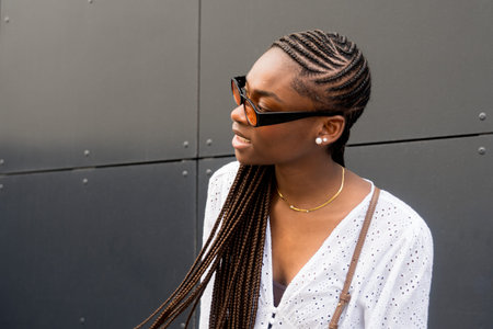 Street style. Beautiful female model with an afro-style braided hairstyle. Copy space.