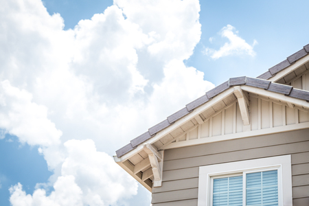 House Window and Roof with Clouds in the Skyの写真素材