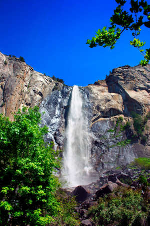 Bridal Veil tumbles 620' from the top, and one of the few falls in Yosemite to run all year. As you stand at the bottom and look up, the mist created at the top has a wonderful, veil-like quality to it during most of the year. However, it the spring, it tの写真素材