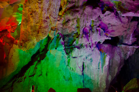 beautiful illuminated multicolored stalactites from karst Reed Flute cave. Guilin Guangxi Chinaの写真素材