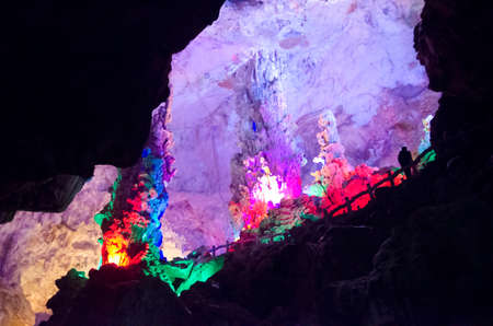 beautiful illuminated multicolored stalactites from karst Reed Flute cave. Guilin Guangxi Chinaの写真素材