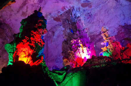 beautiful illuminated multicolored stalactites from karst Reed Flute cave. Guilin Guangxi Chinaの写真素材