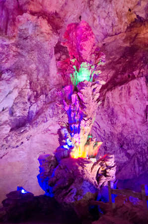 beautiful illuminated multicolored stalactites from karst Reed Flute cave. Guilin Guangxi Chinaの写真素材