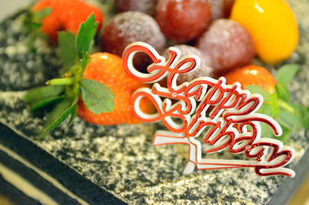 Happy Birthday candles on chocolate cakeの写真素材