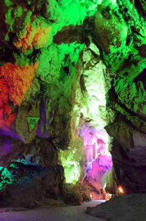 beautiful illuminated multicolored stalactites from karst Reed Flute cave. Guilin Guangxi Chinaの写真素材