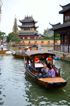 Old village by river in Shanghai with boat