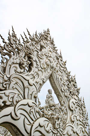 White Buddha sits  deep in meditation with white rayの写真素材