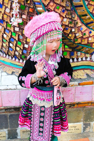 Chiang Mai,Thailand - January 15 : A cute girl looks like  hill tribe invites travelers to take photo with her for tuition on January 15,2011 in Doi suthep Chiang mai ,Thailand.  のeditorial素材