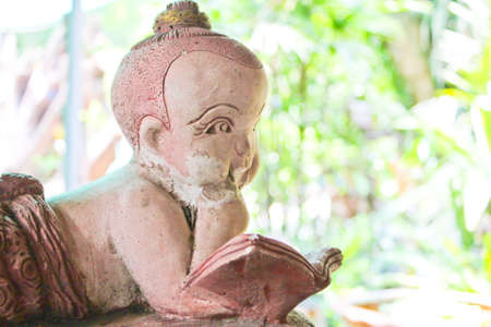 Funny child sculpture is reading a book.のeditorial素材