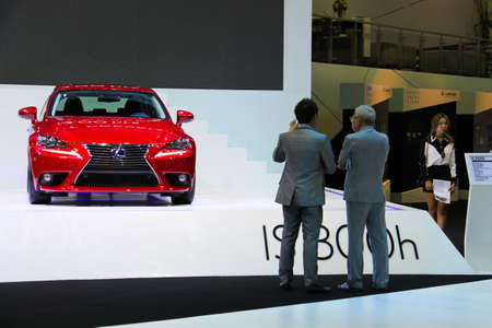 BANGKOK, THAILAND - April 2- Sale executive tells the customer about Red Lexus that is shown in Bangkok international motor show 2013 on April 2, 2013 in Bangkok, Thailand.のeditorial素材