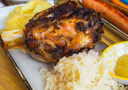 Roasted pork knuckle with potato and saladの写真素材