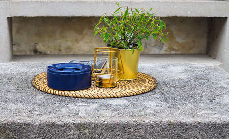 food carrier, lamp, flower pot and book on wooden trayの写真素材