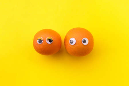 Orange with eyes yellow background.の写真素材