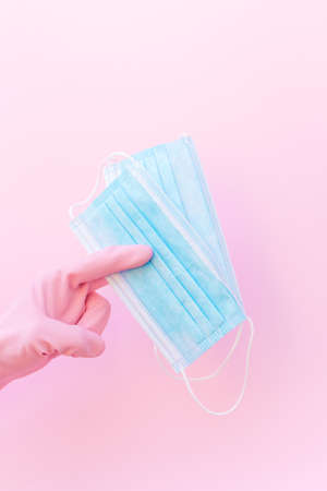 Hand in gloves holding masks