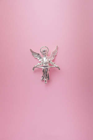 Angel flying on a pink backgroundの写真素材