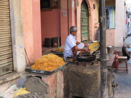 Indian man cooking noodles at his shop in Nimaj, Indiaのeditorial素材