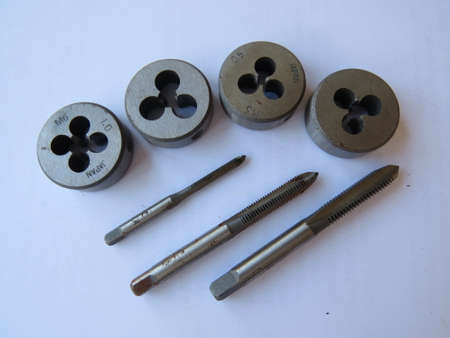 Taps and dies used in engineering to cut threads.