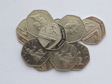 Small pile of UK fifty pence coinsの写真素材