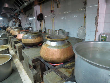 Food cooking in a kitchen owned by a local mosque in Rajasthan, India. The food is given away to the poor people of the area.のeditorial素材