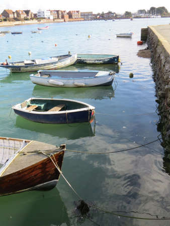 Small boats floating in Emsworth harbour, UK.の写真素材