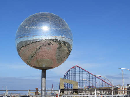 Giant Glitter ball on the promenade at Blackpool with the roller coaster in the background.の写真素材