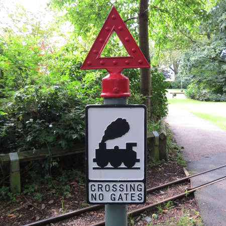 Railway crossing warning sign on a miniature railway.の写真素材