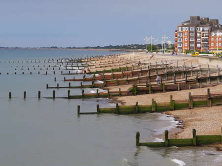 Coastal defences on an English beach. These wooden structures prevent the beach being washed away by the tides.の写真素材