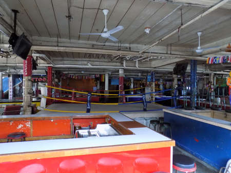 Pattaya, Thailand - November 3rd, 2015: Collection of open beer bars grouped around a Thai boxing ring. These bars cater primarily for tourists and put on Thai boxing exhibitions on a nightly basis.のeditorial素材