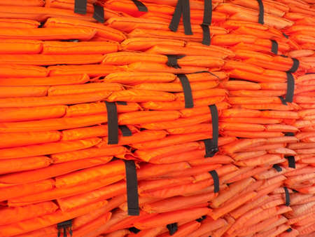 Background of a stack of life jackets on a small ferry.