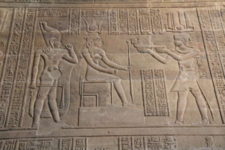 Carvings on a ruined temple wall in Luxor, Egypt.