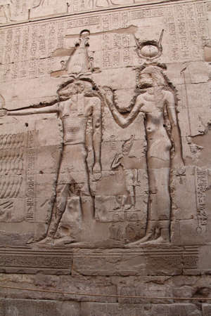 Carvings on a ruined temple wall in Luxor, Egypt.