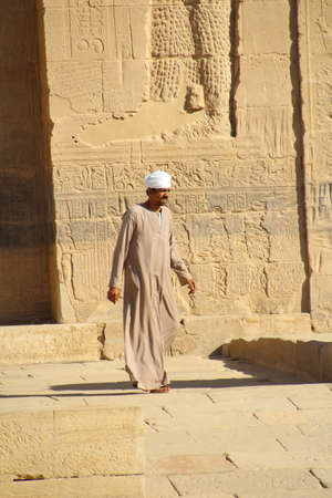 Aswan, Egypt - December 1, 2016: Guide at the entrance to one of the temples a Abu Simbel. A wealth of information, they can be hired for guided tours at very little cost.のeditorial素材