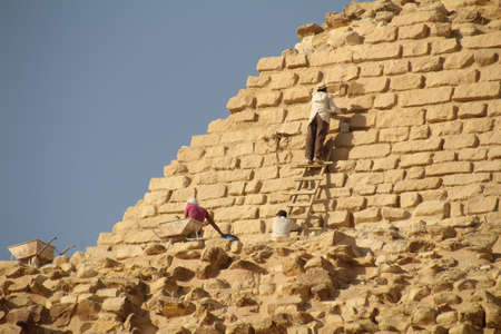 Giza, Egypt - November 26, 2016: Repair work being carried out on a step pyramid at Giza near Cairo. The work involves doing the minimum amount of changes to ensure the structure remains intact for future generations to enjoy.のeditorial素材