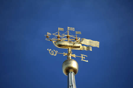 Weather vain on top of the cathedral in Old Portsmouth. The nautical theme pays homage to the naval history of the city.の写真素材
